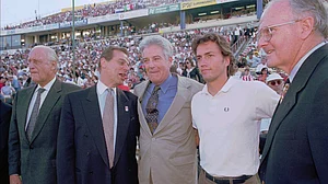 (AP Photo/Craig Fujii, File) : From right, Major League Soccer owners representative Lamar Hunt, actor Andrew Shue, Commissioner Douglas Logan, Chairman Alan Rothenberg, and FIFA representative Joao Havelange gather on the field before the start of the league's inaugural game in San Jose, Calif., April 6, 1996.