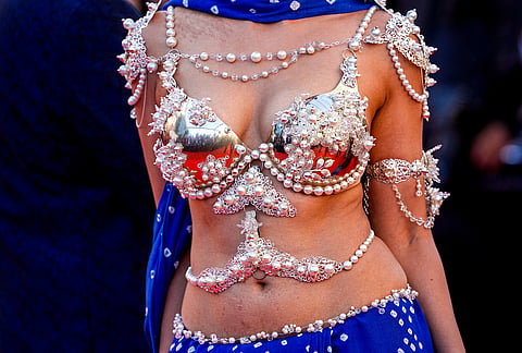 Members of the media are reflected in a woman's bra as she walks on the red carpet at the premiere of the film 'Hope' at the 79th international film festival, Cannes, southern France.