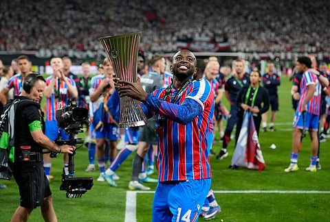 Crystal Palace's Jean-Philippe Mateta celebrates with the trophy after the Europa Conference League final soccer match between Crystal Palace and Rayo Vallecano in Leipzig, Germany.