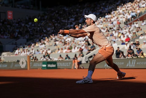 Novak Djokovic of Serbia returns to Valentin Royer of France during their second round men's singles tennis match at the French Open tennis tournament in Paris.