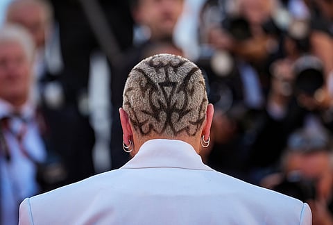 Quentin Mosimann poses for photographers upon arrival at the premiere of the film 'Karma' at the 79th international film festival, Cannes, southern France.