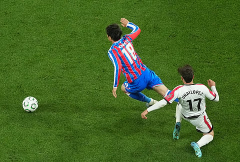 Rayo's Unai Lopez, right, tackles Crystal Palace's Daichi Kamada during the Europa Conference League final soccer match between Crystal Palace and Rayo Vallecano in Leipzig, Germany.