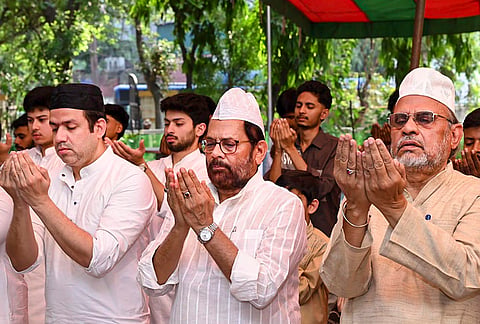 Former union minister Mukhtar Abbas Naqvi, centre, offers prayers on the occasion of Eid al-Adha, in New Delhi. 