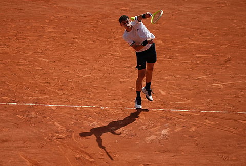Juan Manuel Cerundolo of Argentina serves to Jannik Sinner of Italy during their second round men's singles tennis match at the French Open tennis tournament in Paris.