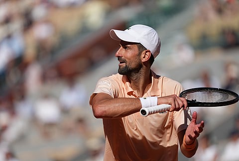 Novak Djokovic of Serbia reacts as he plays against Valentin Royer of France during their second round men's singles tennis match at the French Open tennis tournament in Paris.