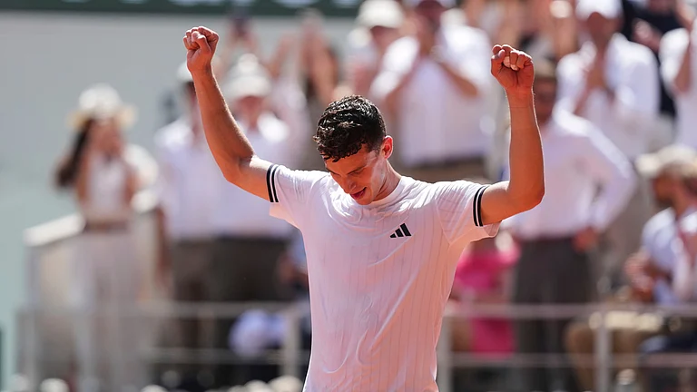 Juan Manuel Cerundolo of Argentina celebrates winning against Jannik Sinner of Italy after their second round men's singles tennis match at the French Open tennis tournament in Paris, Thursday, May 28, 2026. - (AP Photo/Thibault Camus)