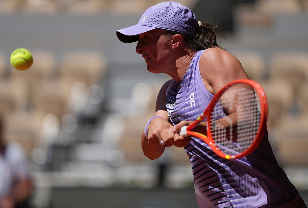 Iga Swiatek of Poland returns to Sara Bejlek of the Czech Republic during their second round women's singles tennis match at the French Open tennis tournament in Paris. - | Photo: AP/Thibault Camus