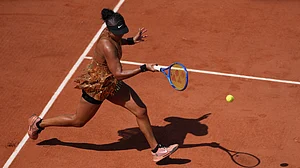 (AP Photo/Thibault Camus) : Naomi Osaka of Japan returns to Donna Vekic of Croatia during their second round women's singles tennis match at the French Open tennis tournament in Paris, Thursday, May 28, 2026.