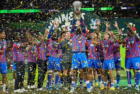 Crystal Palace players celebrate with a trophy after the Europa Conference League final soccer match between Crystal Palace and Rayo Vallecano in Leipzig, Germany.