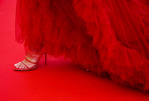 A woman walks on the red carpet upon arriving at the premiere of the film 'Fjord' at the 79th international film festival, Cannes, southern France, Monday, May 18, 2026. 