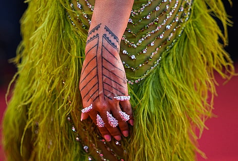 A woman walks on the red carpet at the opening ceremony and premiere of the film 'The Electric Kiss' during 79th international film festival, Cannes, southern France.