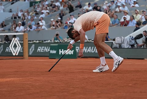 Novak Djokovic of Serbia celebrates after winning against Valentin Royer of France during their second round men's singles tennis match at the French Open tennis tournament in Paris.
