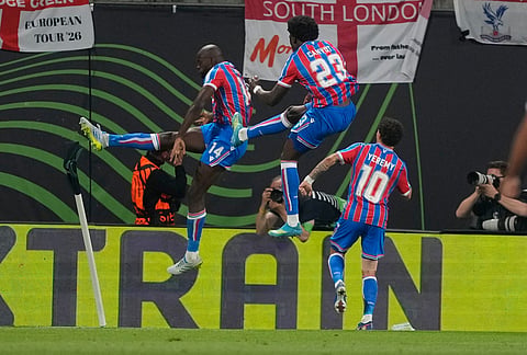 Crystal Palace's Jean-Philippe Mateta, left, celebrates with teammates after scoring the opening goal of his team during the Europa Conference League final soccer match between Crystal Palace and Rayo Vallecano in Leipzig, Germany.
