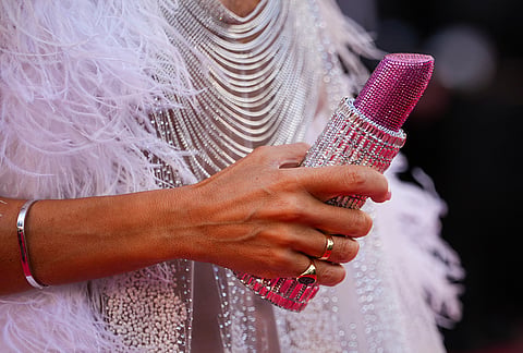 Lady Victoria Hervey holds a lipstick shaped purse upon arrival at the premiere of the film 'A Woman's Life' at the 79th international film festival, Cannes, southern France.