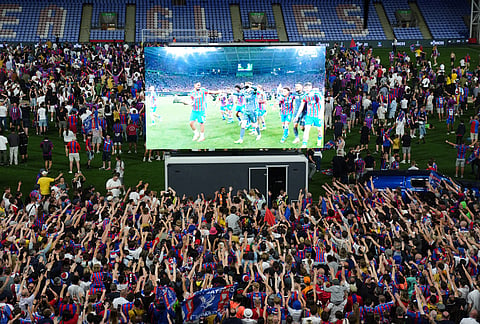 Crystal Palace fans celebrate their team's win as they watch a screening of the Europa Conference League final soccer match between Crystal Palace and Rayo Vallecano, at Selhurst Park in London. 