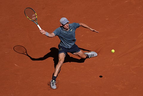 Valentin Royer of France returns to Novak Djokovic of Serbia during their second round men's singles tennis match at the French Open tennis tournament in Paris.