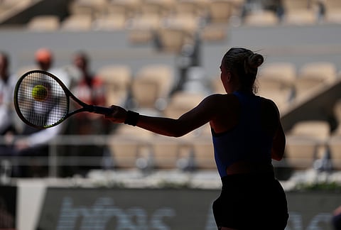 Sara Bejlek of the Czech Republic returns to Iga Swiatek of Poland during their second round women's singles tennis match at the French Open tennis tournament in Paris.