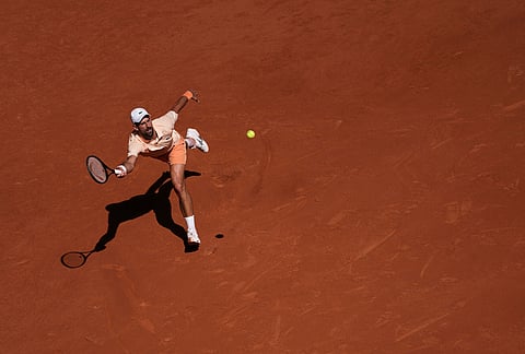 Novak Djokovic of Serbia returns to Valentin Royer of France during their second round men's singles tennis match at the French Open tennis tournament in Paris.