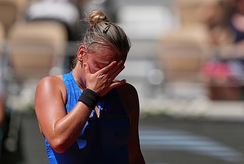 Sara Bejlek of the Czech Republic reacts as she plays against Iga Swiatek of Poland during their second round women's singles tennis match at the French Open tennis tournament in Paris.