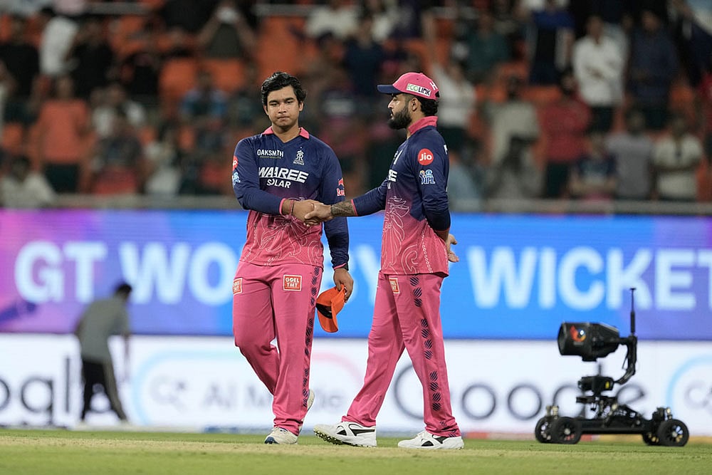 Rajasthan Royals' Vaibhav Sooryavanshi shakes hand with his captain Riyan Parag after Gujarat Titans won against Rajasthan Royals during the Indian Premier League cricket match in New Chandigarh, India. - | Photo: AP/Ashwini Bhatia