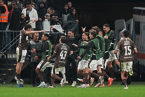 Franco Zapiola of Argentina's Platense, left, celebrates with teammates after scores his side's second goal against Brazil's Corinthians during a Copa Libertadores Group E soccer match in Sao Paulo.