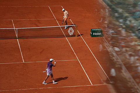 Joao Fonseca of Brazil, bottom, celebrates as he plays against Novak Djokovic of Serbia during their third round men's singles tennis match at the French Open tennis tournament in Paris.
