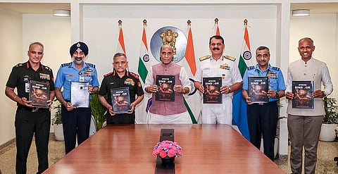 Union Defence Minister Rajnath Singh in a photograph with Chief of Defence Staff General Anil Chauhan, Chief of the Air Staff, Air Chief Marshal AP Singh, Chief of the Naval Staff Admiral Dinesh K Tripathi and others during the release of a book on Operation Sindoor, in New Delhi. 