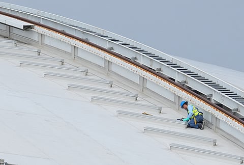A worker labors on the roof of AT&T Stadium, which will be named Dallas Stadium during the 2026 FIFA World Cup, as preparations continue at the venue ahead of the soccer tournament, in Arlington.