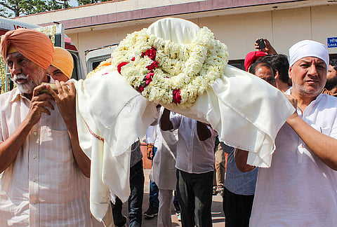 Family members of veteran Indian sports administrator Randhir Singh, carry the latter's mortal remains during last rites, at Chandi Ghat in Haridwar.