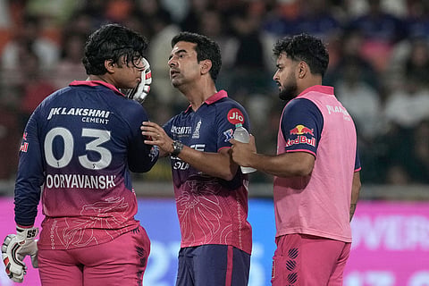 A team medic checks Rajasthan Royals' Vaibhav Sooryavanshi after a ball hits Sooryavanshi's helmet during the Indian Premier League cricket match between Gujarat Titans and Rajasthan Royals in New Chandigarh, India.