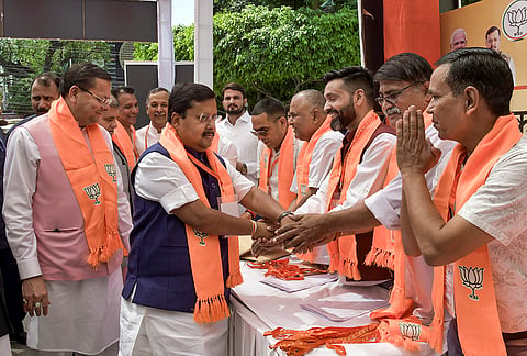 BJP National President Nitin Nabin being received by party workers upon his arrival at a hotel ahead of meetings related to the upcoming Uttarakhand Assembly elections, in Dehradun. State Chief Minister Pushkar Singh Dhami is also present. 