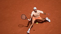 (AP Photo/Christophe Ena) : Novak Djokovic of Serbia returns to Joao Fonseca of Brazil during their third round men's singles tennis match at the French Open tennis tournament in Paris, Friday, May 29, 2026.
