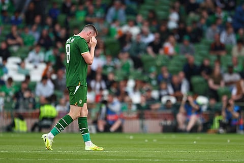 Ireland's Jack Moylan leaves the pitch after being shown a red card during the international friendly soccer match between Ireland and Qatar in Dublin, Ireland.