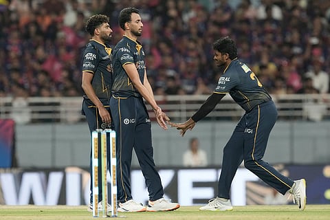 Gujarat Titans' Prasidh Krishna, center, celebrates the wicket of Rajasthan Royals' Jofra Archer with with teammates during the Indian Premier League cricket match between Gujarat Titans and Rajasthan Royals in New Chandigarh, India.
