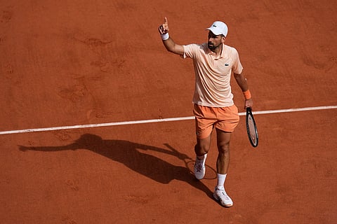 Novak Djokovic of Serbia gestures as he plays against Joao Fonseca of Brazil during their third round men's singles tennis match at the French Open tennis tournament in Paris.