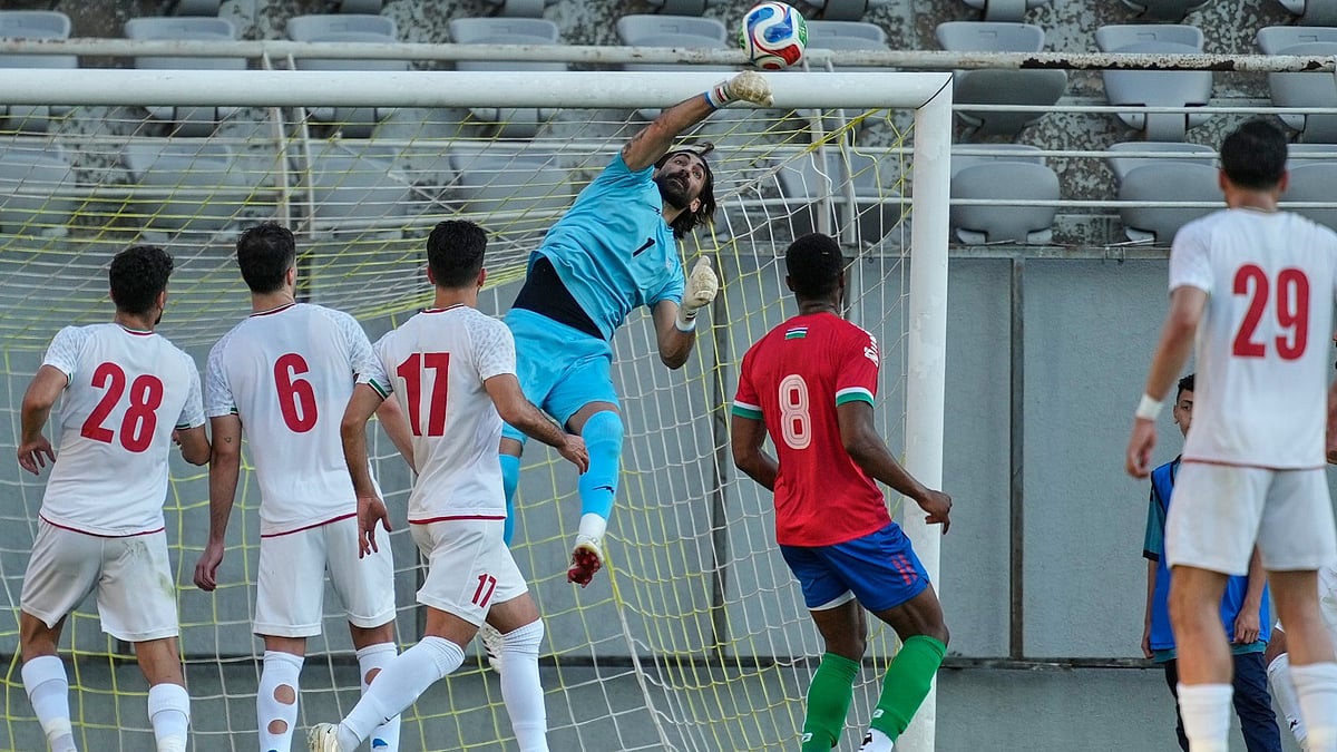 Iran's goalkeeper Alireza Beiranvand punches the ball clear during a friendly soccer match between Iran and Gambia, in Antalya, southern Turkey. - AP Photo