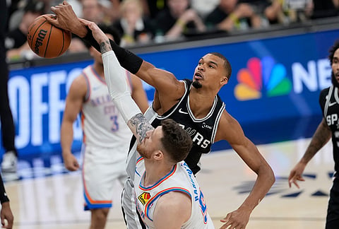 San Antonio Spurs forward Victor Wembanyama (1) and Oklahoma City Thunder center Isaiah Hartenstein (55) vie for a rebound in the first half of Game 6 in the Western Conference finals NBA basketball playoffs series, in San Antonio. 
