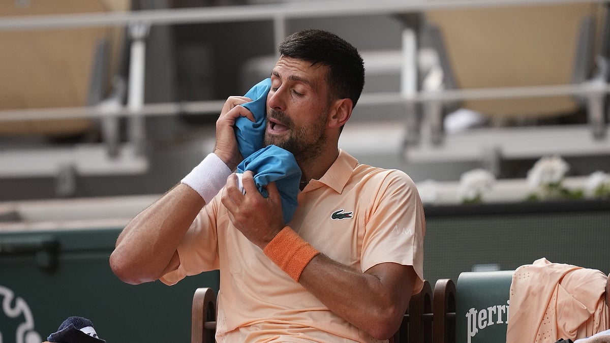 Novak Djokovic of Serbia cools himself during a break of the third round men's singles tennis match against Joao Fonseca of Brazil at the French Open tennis tournament in Paris, Friday, May 29, 2026. - (AP Photo/Christophe Ena)