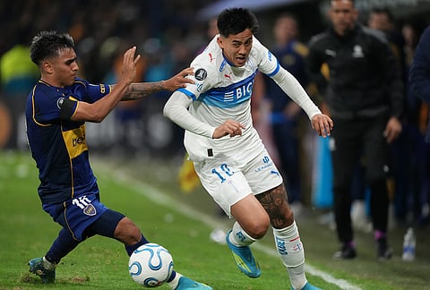 Matias Palavecino of Chile's Universidad Catolica, right, and Milton Delgado of Argentina's Boca Juniors during a Copa Libertadores Group D soccer match in Buenos Aires, Argentina.