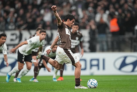 Franco Zapiola of Argentina's Platense scores from the penalty spot against Brazil's Corinthians during a Copa Libertadores Group E soccer match in Sao Paul.