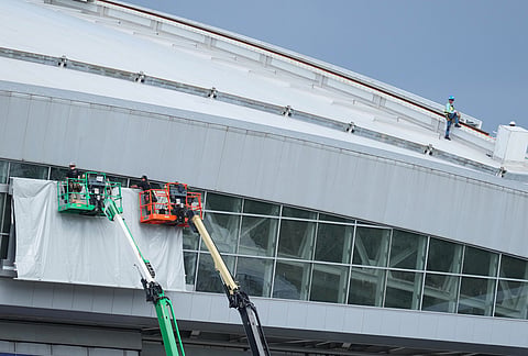 Signage on the exterior of AT&T Stadium, which will be named Dallas Stadium during the 2026 FIFA World Cup, is covered by workers as preparations continue at the venue ahead of the soccer tournament, in Arlington.