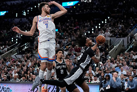 San Antonio Spurs guard Stephon Castle (5) shoots against Oklahoma City Thunder center Chet Holmgren (7) in the first half of Game 6 in the Western Conference finals NBA basketball playoffs series, in San Antonio. 