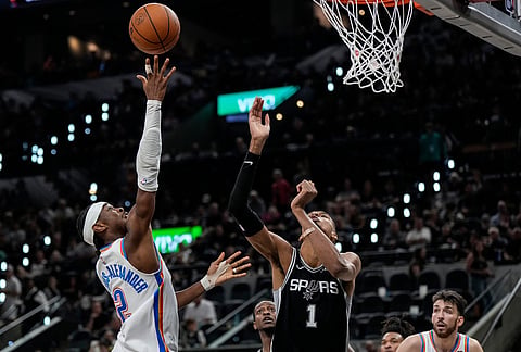 Oklahoma City Thunder guard Shai Gilgeous-Alexander (2) shoots against San Antonio Spurs forward Victor Wembanyama (1) in the second half of Game 6 in the Western Conference finals NBA basketball playoffs series, in San Antonio.