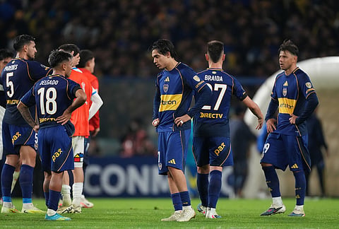 Players of Argentina's Boca Juniors stand on the field after a loss to Chile's Universidad Catolica during a Copa Libertadores Group D soccer match in Buenos Aires, Argentina.