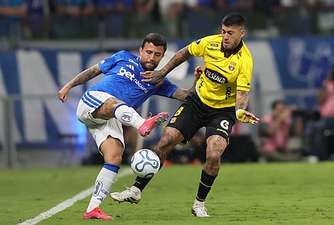 Matheus Henrique of Brazil's Cruzeiro, left, and Milton Celiz of Ecuador's Barcelona battle for the ball during a Copa Libertadores Group D soccer match in Belo Horizonte, Brazil.