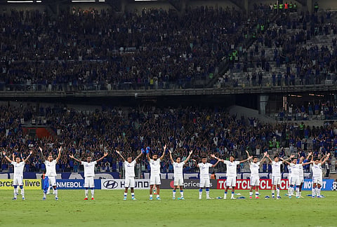 Players of Chile's Universidad Catolica celebrate their team's 1-0 victory over Argentina's Boca Juniors at the end a Copa Libertadores Group D soccer match in Buenos Aires, Argentina.