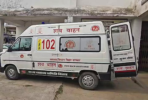 A hearse van stands outside a hospital after another body was recovered from the Ganga river following a boat capsizing incident near Umanath Ganga Ghat in Barh subdivision of Patna district. Search operations for the remaining missing persons are underway. 