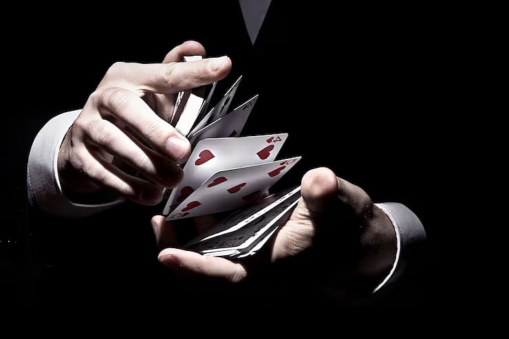 Hands shuffling playing cards