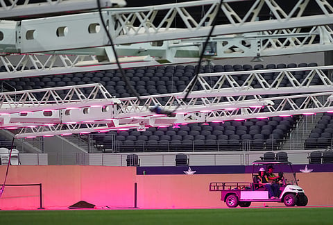 Workers ride a cart near the field during a preview of the grass installed at Dallas Stadium, in Arlington, Texas, ahead of the 2026 FIFA World Cup soccer tournament. 