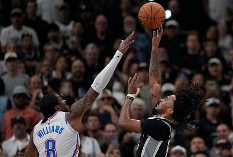 San Antonio Spurs guard Stephon Castle (5) shoots over Oklahoma City Thunder guard Jalen Williams (8) in the second half of Game 6 in the Western Conference finals NBA basketball playoffs series, in San Antonio.